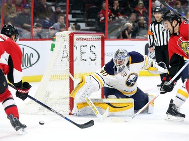 Kyle Turris, left, and Mark Stone, right, of the Ottawa Senators can't score on Robin Lehner of the Buffalo Sabres during first period NHL action.