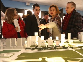 Marina and Dmitry Belik talk with Philip Elanger at the Canadian War Museum in Ottawa Wednesday Jan 27, 2016.The general public got a chance to attend the public viewing of the LeBreton Flats development proposals at the Museum Wednesday.  Tony Caldwell/Postmedia Network