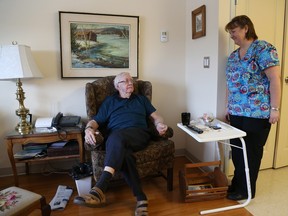 Louise Poirier, an attendant, chats with Joseph Doyle in his room which is part of a cluster in the Village at Bruyere Continuing Care in Ottawa.