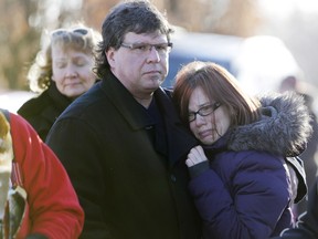 Margit and Attila mourn the loss of their son Jason Simon at a remembrance ceremony honouring Canadian Forces members who have died by suicide, at Beechwood Cemetery in Ottawa on Feb. 21, 2016.