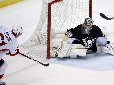 Ottawa Senators' Mark Stone (61) puts the puck past Pittsburgh Penguins goalie Marc-Andre Fleury (29) for a goal during the first period.