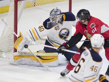 Buffalo Sabres' goalie Robin Lehner knocks away a shot from Ottawa Senators' right wing Mark Stone (61) as Sabres' Cody Franson looks on during first period NHL action.