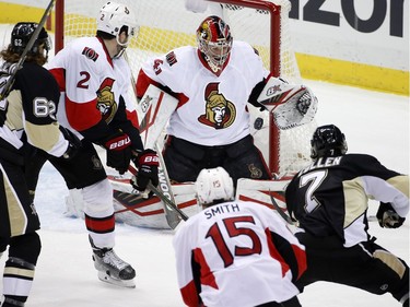 Pittsburgh Penguins' Matt Cullen (7) takes a shot against Ottawa Senators goalie Craig Anderson (41) during the first period.