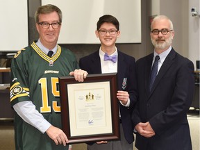 Mayor Jim Watson and Kitchissippi ward Coun. Jeff Leiper present a Mayor's City Builder Award to Jonathan Chow.