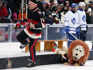 Spartacat makes a dive onto the ice to retrieve a piece of garbage that blew onto the ice.