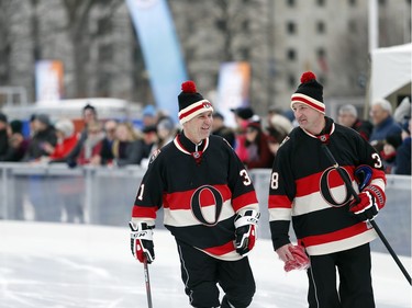 Sens alumni, L-R: Ed Staniowski and Brad Smyth warm up with a skate around the ice.