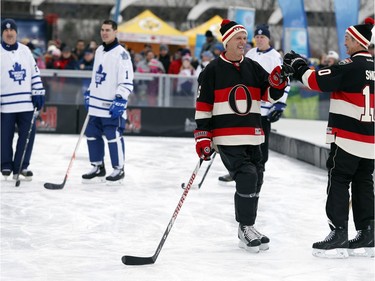 Laurie Boschman bumps fists with Rick Smith as they were introduced.