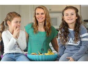 Michelle Vodrazka, a former fitness model and figure competitor, completely changed her family's diet to nutrition-dense dishes when her youngest daughter, Noelle, now 6 (left), got sick. After two years on the new regime, her little girl was back to normal, she says. Now, the mother of four (including her second youngest daughter, Maya, 7 (right), has written a cook book featuring 120 of her gluten and dairy-free healthy recipes. (JULIE OLIVER/POSTMEDIA NETWORK)