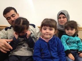Moustafa Yousef, left, with daughters Bayan, 7, Aya, 4, Miriam , 2 and wife Amal, were staying temporarily at the Travelodge Hotel while they waited for settlement workers to find them a place to live.