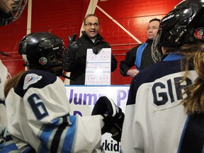 Nalin Bhargava, president of the Girl's Hockey Association, gives a pep-talk to the team he co-coaches at Brian Kilrea Arena Tuesday February 23, 2016.