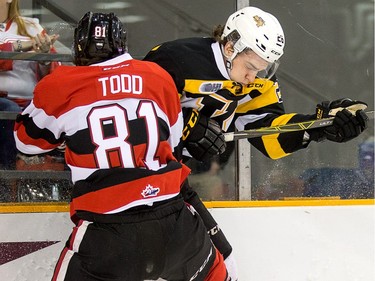 Nathan Todd, left, and Ted Nichol collide along the boards in the first period.