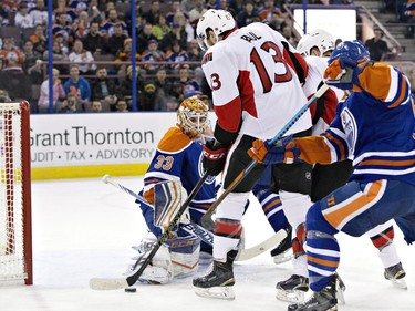 Ottawa Senators ' Nick Paul (13) scores a goal on Edmonton Oilers goalie Cam Talbot (33) during first period NHL action.
