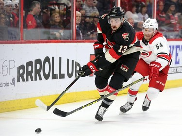 Nick Paul of the Ottawa Senators  is defended by Brett Pesce of the Carolina Hurricanes during first period NHL action.