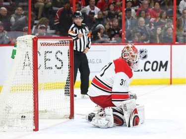 The puck beats Eddie Lack of the Carolina Hurricanes during first period NHL action.