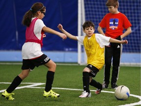 Obai Altalli, 8, in yellow, plays in a Syrian Refugee Charity Soccer Festival at the OZ Dome Monday February 15, 2016. Altalli has only been in Canada for six weeks after fleeing Syria.