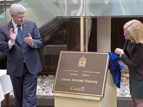 Prime Minister Stephen Harper announces that the federal building at 90 Elgin St. will be named the James Michael Flaherty Building in honour of the former finance minister who passed away on April 10, 2014. At right, Christine Elliott, Flaherty's widow.