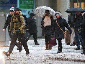 On February 03, 2016, rain was the order of business in Ottawa.  People walking on Bank St. Jean Levac