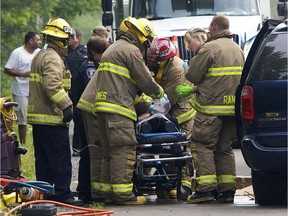 Ottawa Firefighters and Paramedics tend to the driver of a minivan that struck a truck head-on on Merivale Road south of Slack Road. The driver of the minivan was VSA when emergency services arrived.