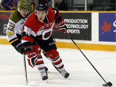 Ottawa 67s' Artur Tyanulin (13) is chased by North Bay Battalion's Brady Lyle (22) during the first period.