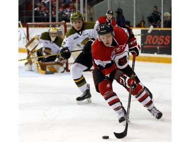 Ottawa 67s' Artur Tyanulin (13) is marked by Brady Lyle (22) of the North Bay Battalion during the first period.