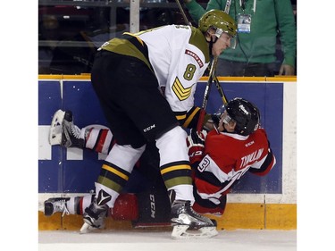 Ottawa 67s' Artur Tyanulin (13) is slammed to the ice by North Bay Battalion's Riley Bruce (8) during the first period.