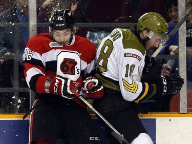 Ottawa 67s' Connor Graham (16) and North Bay Battalion's Mike Amadio (18) collide during the first period.