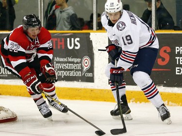 Ottawa 67s' Even de Haan (22) pressures Oshawa Generals' Eric Henderson (19) during the second period.