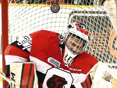 Ottawa 67s' goalie, Leo Lazarev (37) deflects a shot by the Oshawa Generals during the second period.