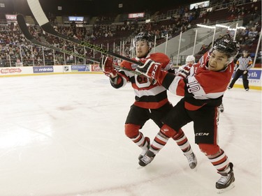 Ottawa 67s' Trent Mallette (26) and Jeremiah Addison (10) clear the puck against the Oshawa Generals during the second period.