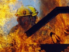 Ottawa firefighters extinguish a simulated car fire at the Ottawa Fire Services Training Centre on Industrial Rd. Thursday, April 16, 2010. A fellow firefighter lost their life while fighting a blaze in Loyalist Township.