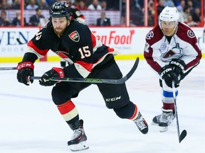 Ottawa Senators center Zack Smith (15) chases a loose puck against Colorado Avalanche right wing Jarome Iginla (12).