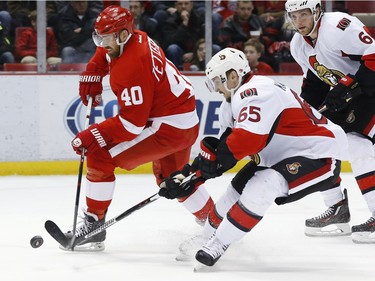 Ottawa Senators defenseman Erik Karlsson (65) defends Detroit Red Wings left wing Henrik Zetterberg (40) in the second period.