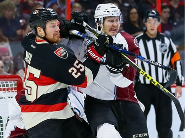 Ottawa Senators right wing Chris Neil (25) battles Colorado Avalanche defenseman Chris Bigras (3).
