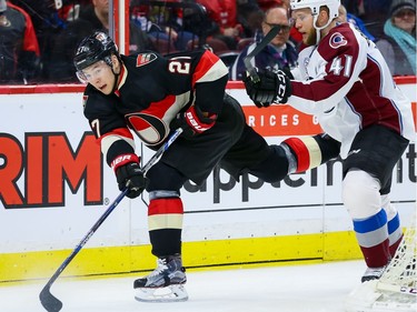 Ottawa Senators right wing Curtis Lazar (27) battles with Colorado Avalanche defenseman Andrew Bodnarchuk (41).