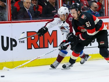 Ottawa Senators right wing Mark Stone (61) battles with Colorado Avalanche center John Mitchell (7).