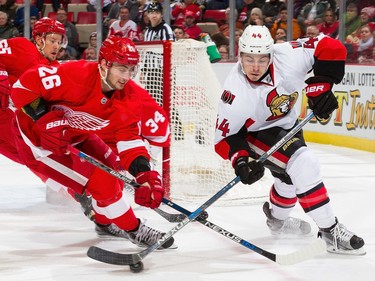 Jean-Gabriel Pageau #44 of the Ottawa Senators battles for the puck with Tomas Jurco #26 of the Detroit Red Wings.