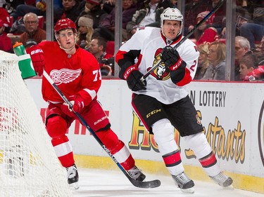 Dion Phaneuf #2 of the Ottawa Senators skates behind the net next to Dylan Larkin #71 of the Detroit Red Wings.