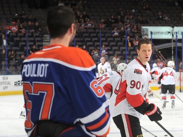 Benoit Pouliot #67 of the Edmonton Oilers exchanges words with Alex Chiasson #90 of the Ottawa Senators prior to the game.