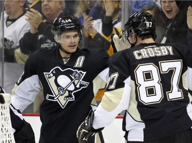 Chris Kunitz #14 of the Pittsburgh Penguins celebrates his first period goal with Sidney Crosby #87.