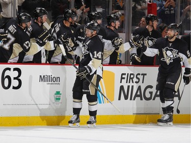 Chris Kunitz #14 of the Pittsburgh Penguins celebrates his first-period goal with the bench.