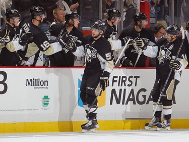 Kris Letang #58 of the Pittsburgh Penguins celebrates his goal with the bench during the first period.