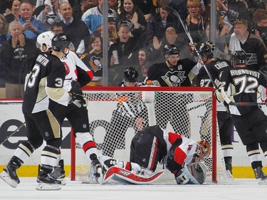 Chris Kunitz #14 of the Pittsburgh Penguins celebrates his goal with teammates in front of Craig Anderson #41 of the Ottawa Senators.