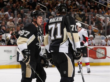 Sidney Crosby #87 of the Pittsburgh Penguins talks with Evgeni Malkin #71 during the second period.
