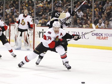 Mark Borowiecki #74 of the Ottawa Senators and Patric Hornqvist #72 of the Pittsburgh Penguins battle for a loose puck.