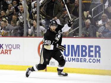 Kris Letang #58 of the Pittsburgh Penguins celebrate his first period goal.
