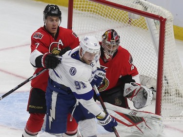 Senator Kyle Turris tries to grab the Lightning’s Steven Stamkos during first period action.