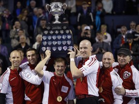 Team Canada skip Pat Simmons, left to right, third John Morris, second Carter Rycroft, lead Nolan Thiessen, alternate Tom Sallows, and coach Earl Morris, lift the Brier Tankard after defeating Northern Ontario to win the gold medal game at the Brier in Calgary on Sunday, March 8, 2015.