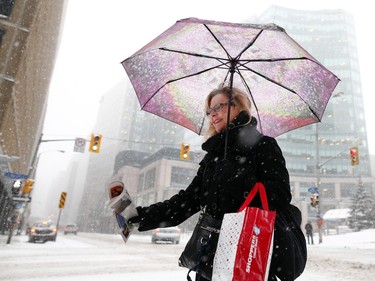 People commute through downtown Ottawa during a winter storm Tuesday.