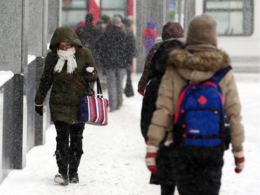 People commute through downtown Ottawa during a winter storm Tuesday February 16, 2016.