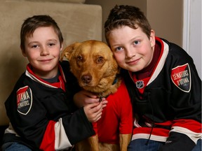 Reece, 7, and Cole, 10, with their new dog Bobby, named after the Ottawa Senators' Bobby Ryan.
